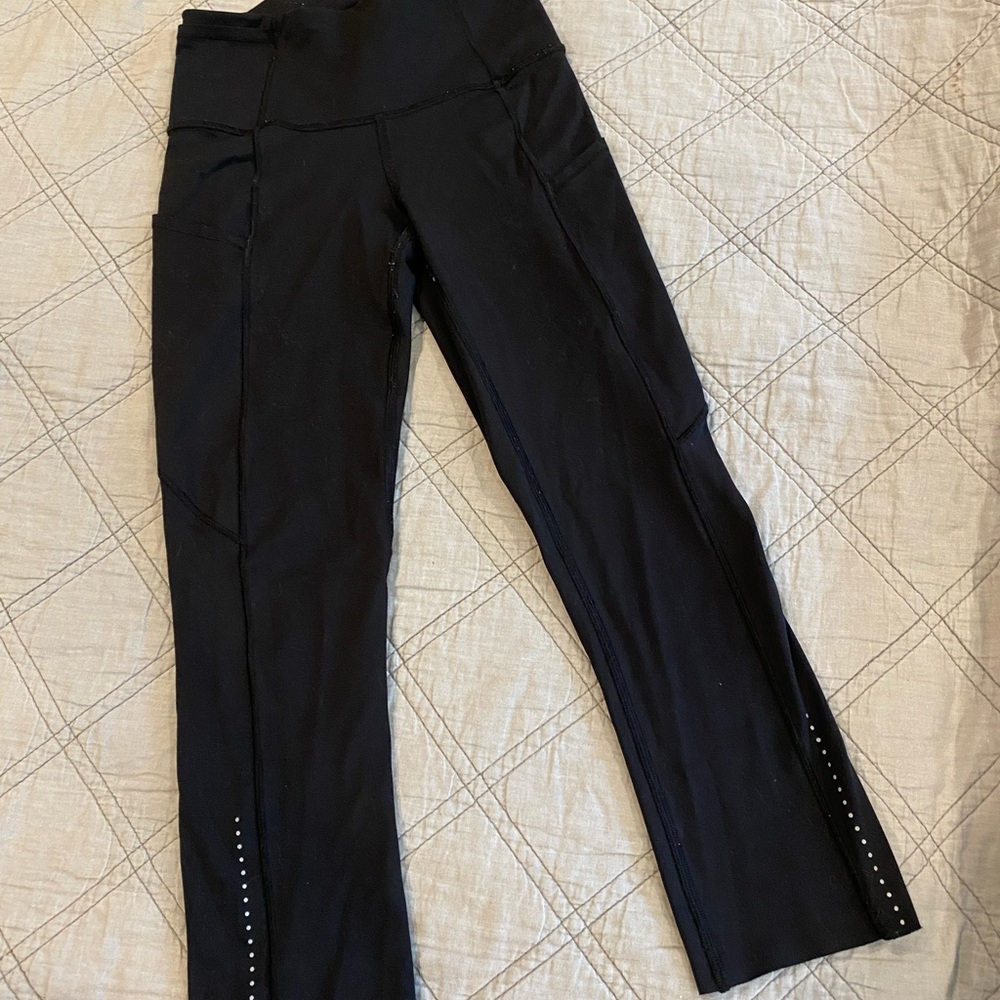 Black Lululemon cropped leggings with silver dot detail